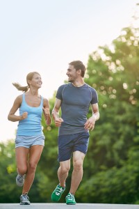 Photo of happy couple running outdoors